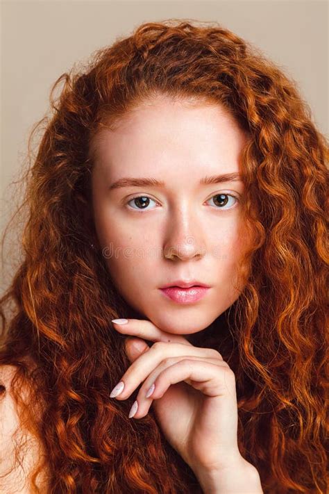 A Beautiful Model With Long Red Curly Hair Brown Eyes And Freckles