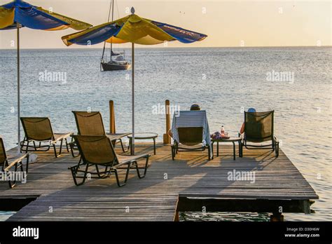 Couple Sitting In Deckchairs On A Wooden Boatdeck Relaxing And Enjoying