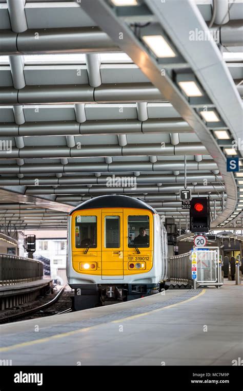 Class 319 Passenger Train In Thameslink Livery Arriving At A Railway