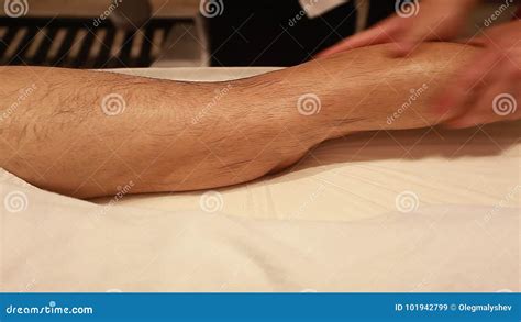 Therapist Giving Leg Massage In Spa Manipulation Of A Calf Muscle Stock