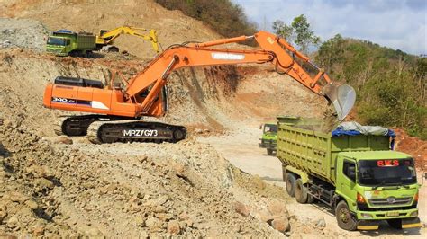 Excavator Digging Loading Dirt Into Dump Truck On Quarry Doosan 340LCV