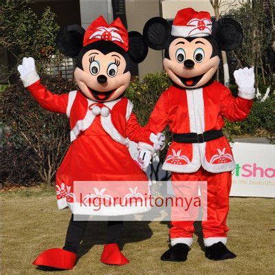 Two People In Mickey And Minnie Mouse Costumes Standing Next To Each