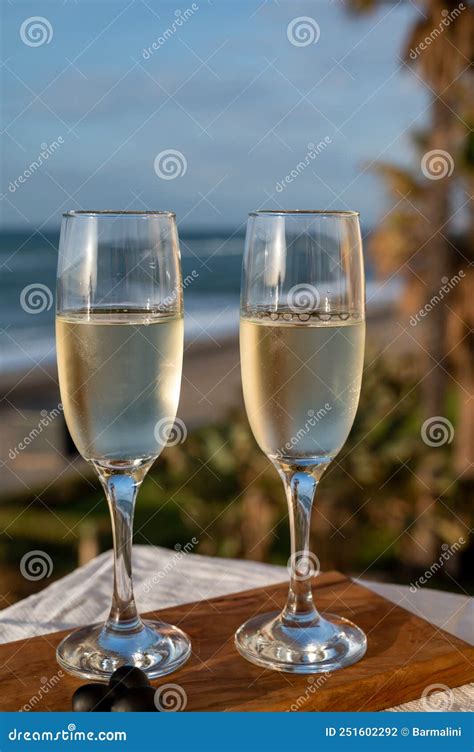 Glasses Of Spanish Cava Sparkling Wine And View On Blue Sea And Sandy Beach Costa Del Sol