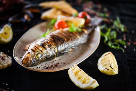 Grilled Fish With Grilled Lemon Sauce Herbs Salt And Pepper Stock Photo