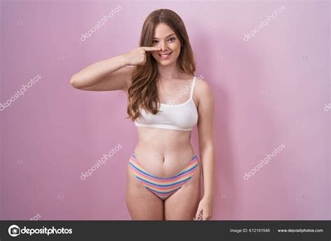 Caucasian Woman Wearing Lingerie Pink Background Pointing Hand Finger