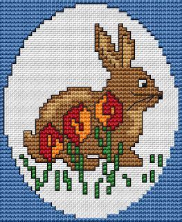 A Cross Stitch Pattern Of A Rabbit And Flowers