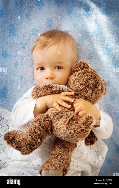 One Year Old Baby Holding A Teddy Bear Stock Photo Alamy