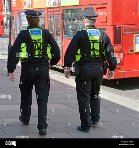 Close Up Back View Of Two Medic Response Police Officers In Uniform