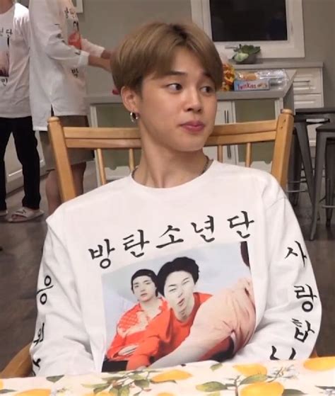 A Young Man Sitting At A Table In Front Of A Woman With An Orange On Her Shirt