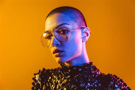 Premium Photo Young Woman With Shaved Head Wearing Eyeglasses Against