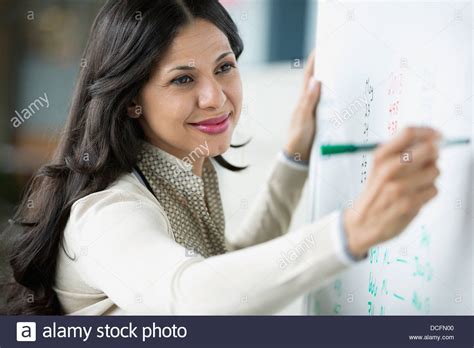 Smiling Businesswoman Writing On Whiteboard Stock Photo Alamy