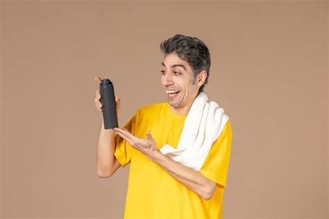 Free Photo Front View Young Male With Foam And Towel Preparing To