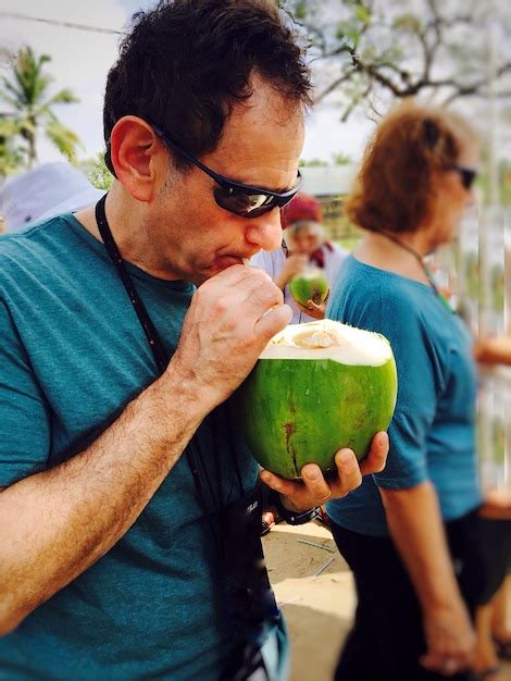 Premium Photo Man Drinking Coconut Outdoors