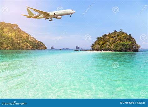 Airplane Flying Over Above Tropical Island In The Sea Stock Photo