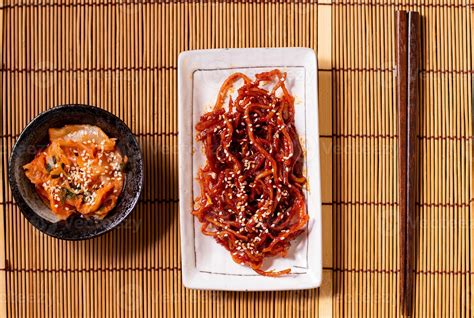 Seasoned Dried Shredded Squid Ojingeochae Muchim With Kimchi On Wood