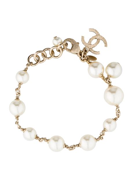 Gold-tone Chanel faux-pearl bracelet with gold-tone CC charm and ...