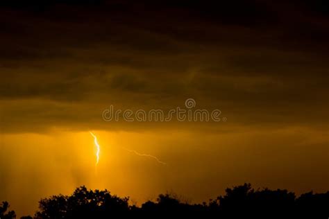 Lightning Strike On The Dark Cloudy Sky Orange Yellow And Red Toned