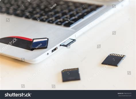 Hand Inserting Sd Card Into Laptop Stock Photo 706252573 Shutterstock