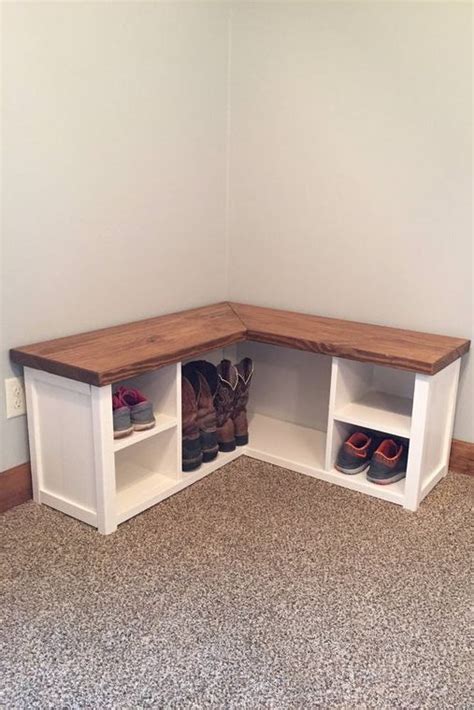 A Corner Bench With Two Cubbys And Shoes On The Bottom Shelf In An