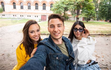 Group Of Happy Friends Taking A Selfie Together In A Stock Photo