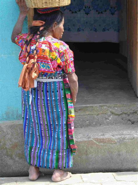 Guatemalan lady going to market in traditional handwoven costume with ikat print threads in ...