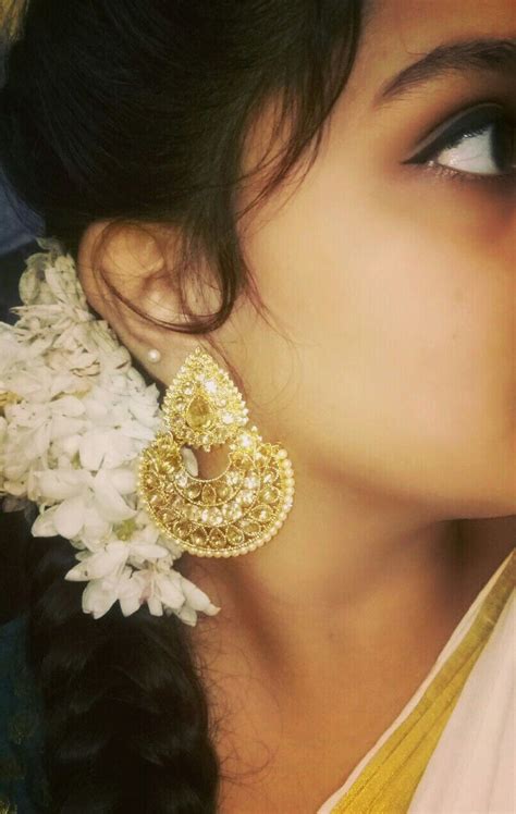 A Onam Saree Styled With A Gorgeous Pair Of Pearl Embedded Earings And