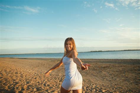 Playful Woman Having Fun On The Beach On The Sunset Cheerful Young