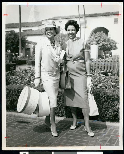 African American Woman Wearing Hat And Carryng Two Hat Boxes Posing With Another Woman Los