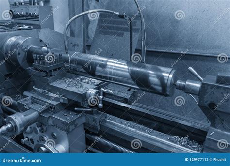 The Operation Of Lathe Machine Cutting The Steel Shaft Stock Photo