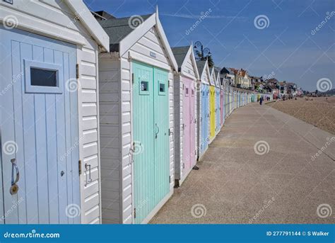 Curving Row Of Pastel Coloured Beach Huts Lyme Regis Dorset England