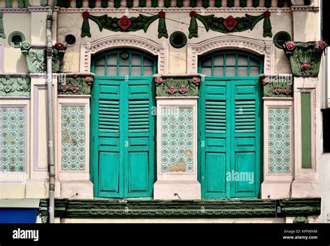 Traditional Singapore Shop House With Green Wooden Shutters And Ornate