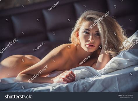 Naked Blonde Woman Looking Camera While Stock Photo 1043499358 Shutterstock