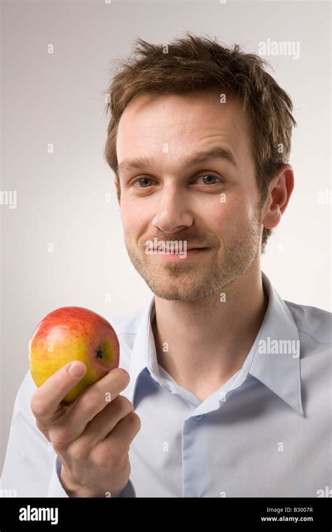 Portrait Of Man Holding Apple Stock Photo Alamy