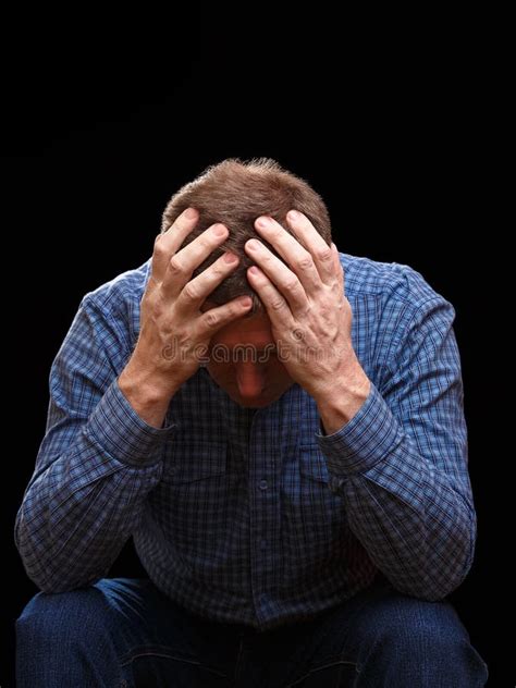 Adult Man Covers His Head With His Hands Looking Down Stock Image