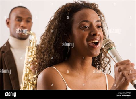 Woman Singing Into Microphone Stock Photo Alamy