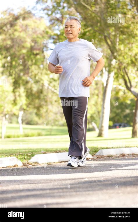 Senior Man Jogging In Park Stock Photo Alamy