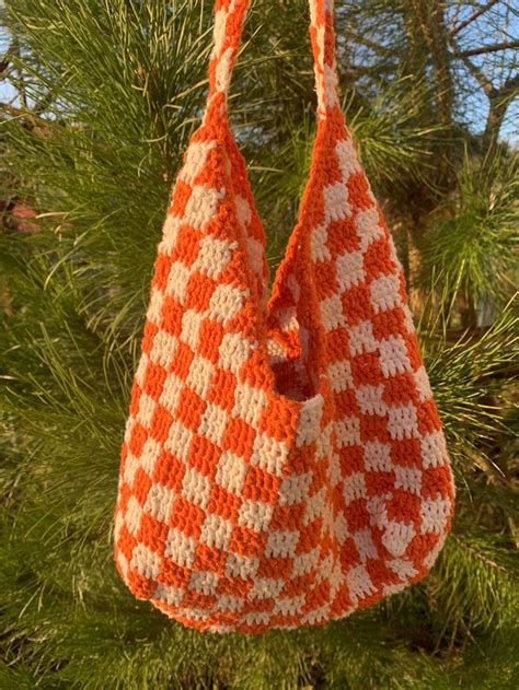 An Orange And White Bag Hanging From A Tree