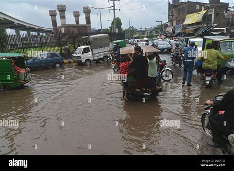 Lahore Pakistan 31st July 2021 Pakistani Commuters Wade Through A Flooded Street After Heavy