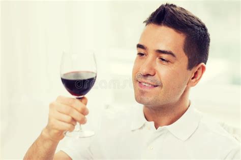 Happy Man Drinking Red Wine From Glass At Home Stock Photo Image