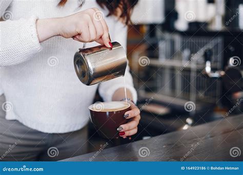 Overhead View Female Barista Pouring Milk Foam Into Cappuchino In Cafe