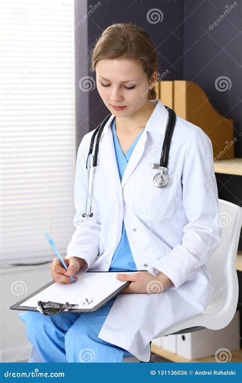 Woman Doctor At Work At Hospital Young Female Physician Write