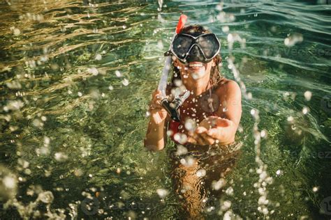 Woman With Scuba Mask Splashing In The Sea Water And Having Fun At