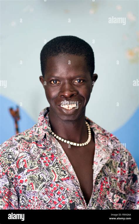 Gambian Man With A Pearl Or Shell Necklace Shirt Open Smiling On The