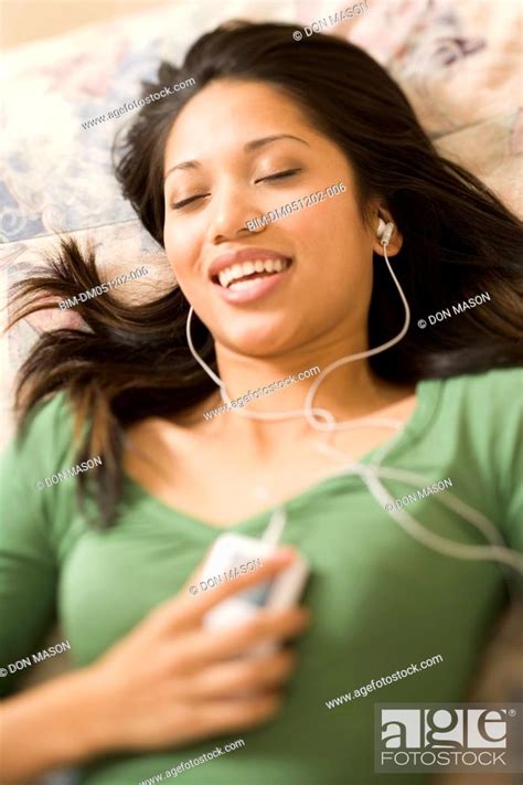 Woman Laying On Bed Listening To Music Stock Photo Picture And