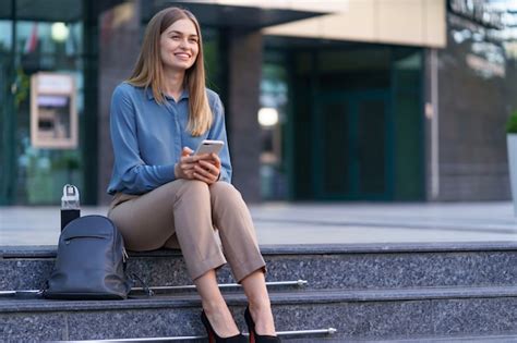 Free Photo Young Professional Woman Sitting On Stair In Front Of