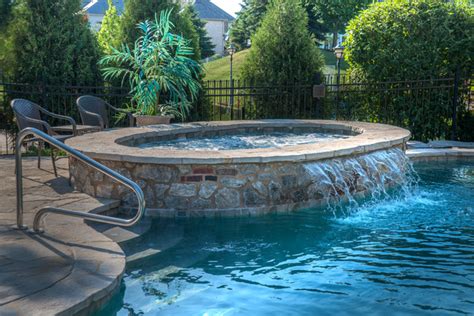 Stone Raised Hot Tub With Sheer Water Feature Coastal Swimming Pool