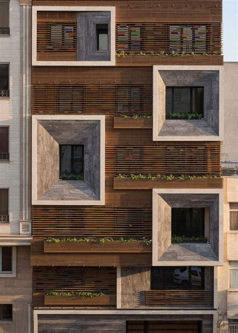 The Facade Of An Apartment Building With Wooden Slats On It S Sides And