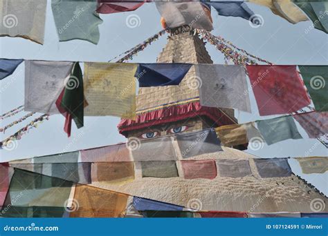 The Top Of Buddhist Stupa Of Bodnath Through The Tibetan Prayer Flags