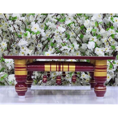 A Wooden Bench Sitting In Front Of White Flowers