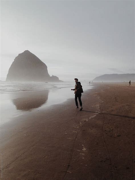 Man Running On Pacific Northwest Beach By Stocksy Contributor KATIE